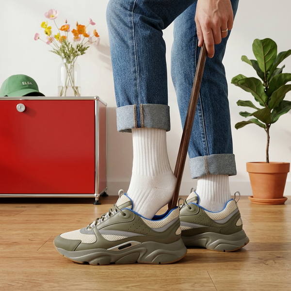 Using the Elsa magnetic beech shoehorn to slip into a sneaker, standing